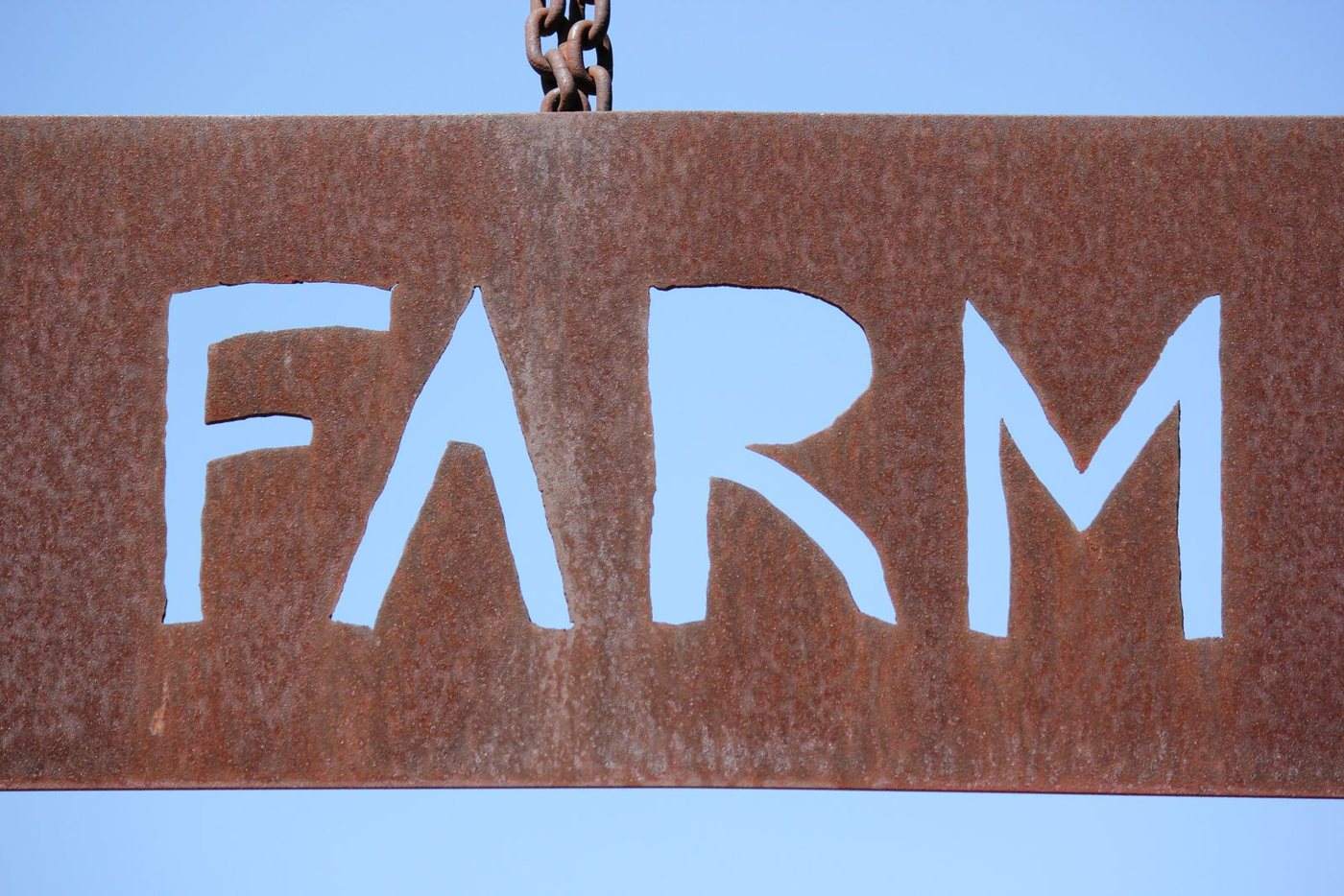 Corten steel sign with laser-cut letters developing a natural rust patina