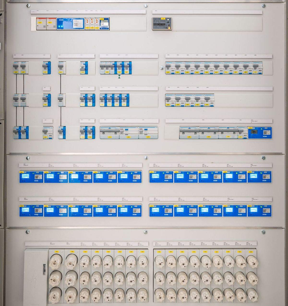 Electrical distribution panel door with laser-cut meter and switch cut-outs